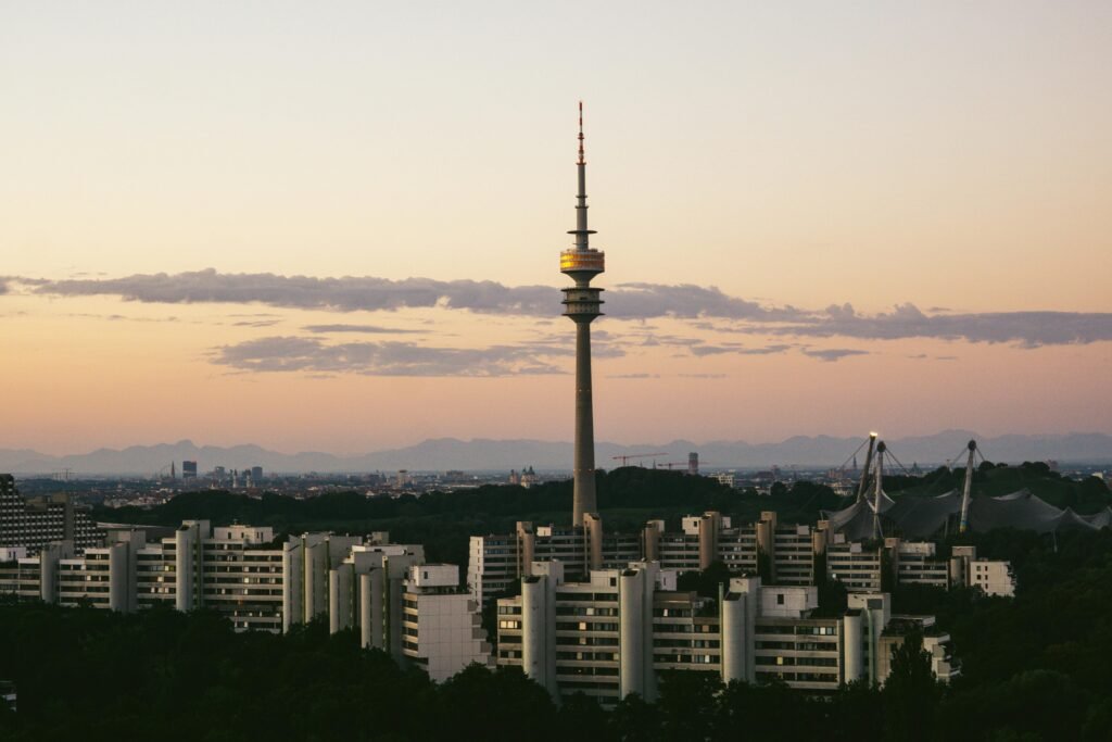 Capture of Munich's skyline featuring the prominent Olympia Tower at dusk with a serene sky.