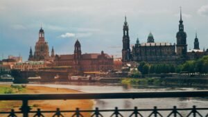 Picturesque cityscape of Dresden featuring historic architecture along the river's edge.