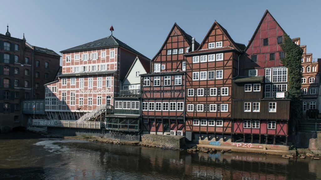 Charming timbered houses in Lüneburg's historic center, reflecting medieval architecture along the river.