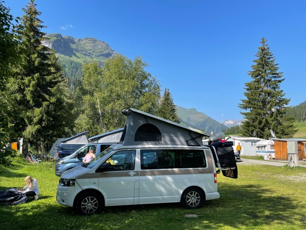 Womo Stellplatz in Rheinwald, Switzerland with a stunning mountain backdrop.