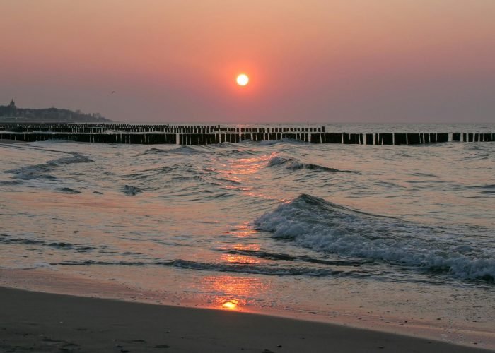 Peaceful sunset over waves at Kühlungsborn beach, Germany. Peaceful sunset over waves at Kühlungsborn beach, Germany.