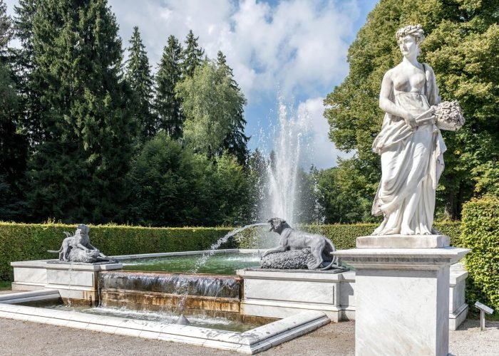 Discover the elegant garden fountain and statues at Herrenchiemsee Castle, Bavaria. Discover the elegant garden fountain and statues at Herrenchiemsee Castle, Bavaria.