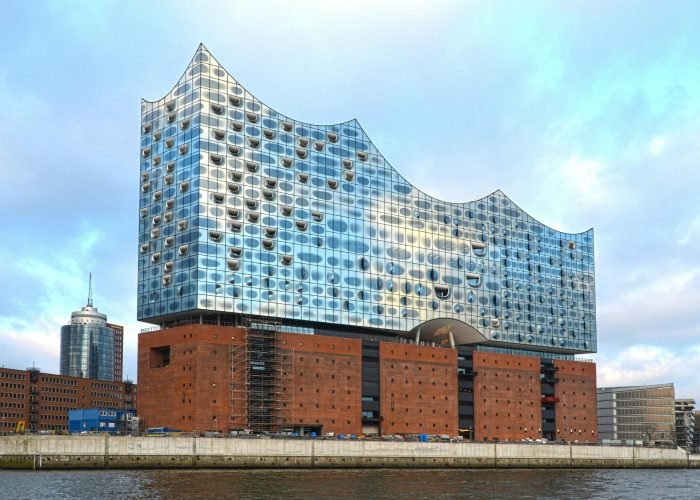 Stunning view of the Elbphilharmonie concert hall reflecting the sky on the Elbe River.