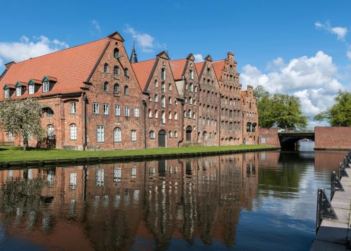 Reflection of the historic Salzspeicher buildings in Lübeck, Germany on a sunny summer day.
