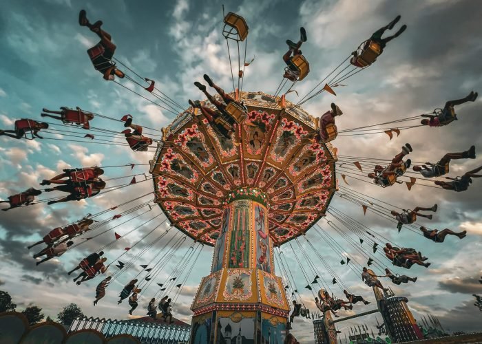 Vibrant swing carousel at a fair with dramatic clouds in Rosenheim, Germany. Vibrant swing carousel at a fair with dramatic clouds in Rosenheim, Germany.