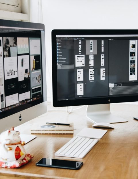 A well-organized design workspace with dual monitors and design software on display. A well-organized design workspace with dual monitors and design software on display.
