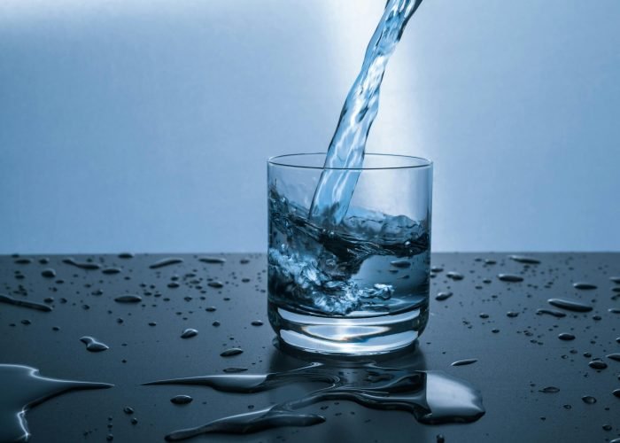 pexels-photo-416528-416528 High-quality image of water being poured into a glass, illustrating hydration and purity.