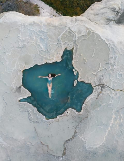 pexels-photo-6942986-6942986 Aerial shot of a woman swimming in a natural thermal pool in Oaxaca, Mexico.