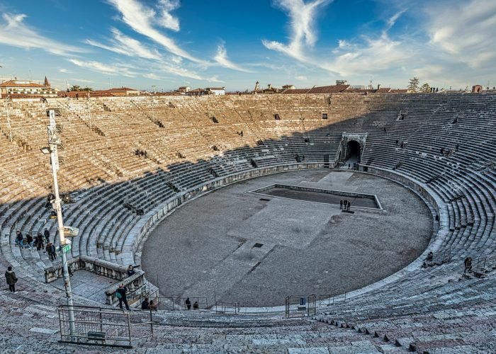 Stunning view of the ancient Verona amphitheatre bathed in sunlight, showcasing its architectural grandeur. Stunning view of the ancient Verona amphitheatre bathed in sunlight, showcasing its architectural grandeur.